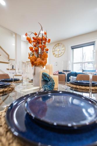 a dining room table with a blue plate on it at North End Entire House in Boston