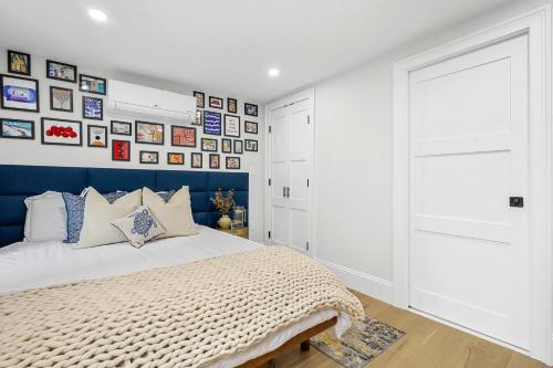 a bedroom with a bed and a wall of pictures at North End Entire House in Boston