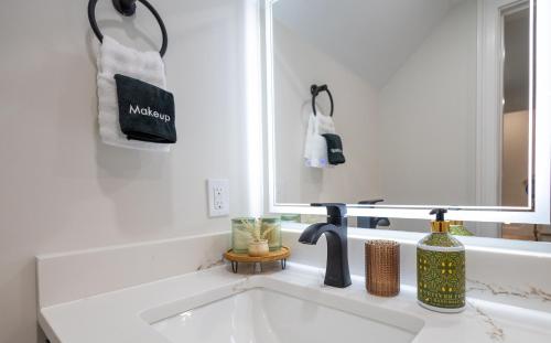 a white bathroom with a sink and a mirror at North End Entire House in Boston