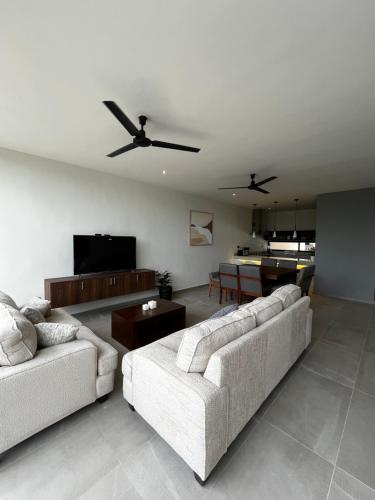 a living room with two couches and a tv at Luxury Villa 03 in Mérida