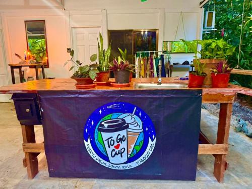 a table with a sign on it with potted plants at Villas Itaita Beach Cabins in Punta Uva