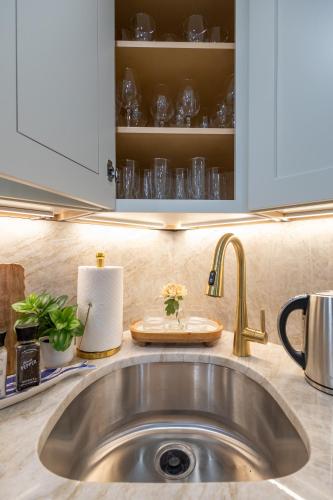 a kitchen counter with a sink and a cupboard at North End Entire House in Boston