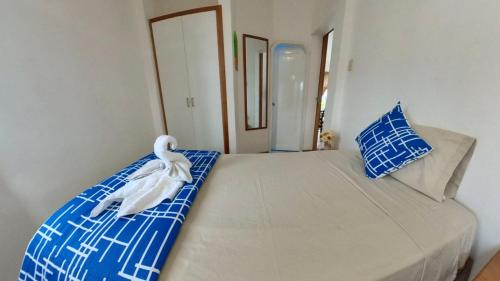 a white swan sitting on top of a bed at The Finch House (La Casa del Pinzón) in Puerto Ayora