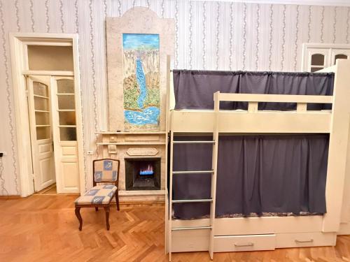 a room with two bunk beds and a fireplace at Nizami Hostel in Baku