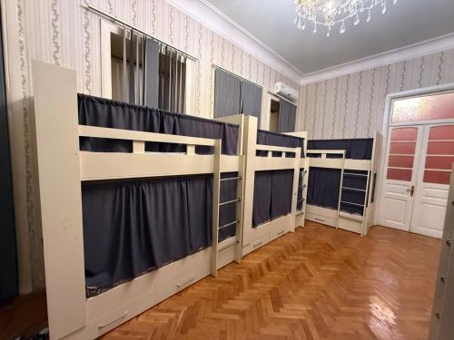a room with three bunk beds in it at Nizami Hostel in Baku