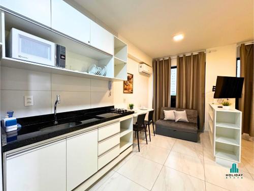 a kitchen with a sink and a microwave at Compact Time by Holiday Stays in João Pessoa