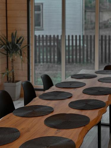 a long wooden table with black chairs around it at Go Карпати in Verkhovyna