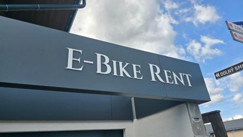 a blue sign that says e bike rent on a building at Villa Greystone in Smokovce