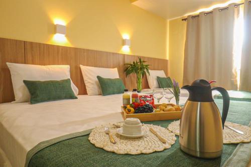 a hotel room with a bed with a tray of fruit at Maren Praia Hotel in São Luís