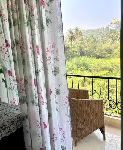 a room with a view of a balcony with curtains at Amber- Sun-Kissed Holidays, Goa in Chicalim