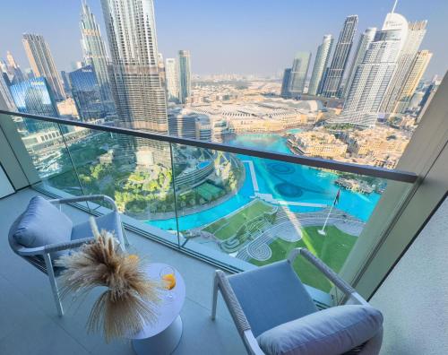 a room with two chairs and a view of a city at GRANDE RESIDENCES with a direct Burj Khalifa view and Private Fountain Show at 62nd floor with DXB AIRPORT VIP Shuttle for 6 guests in Dubai