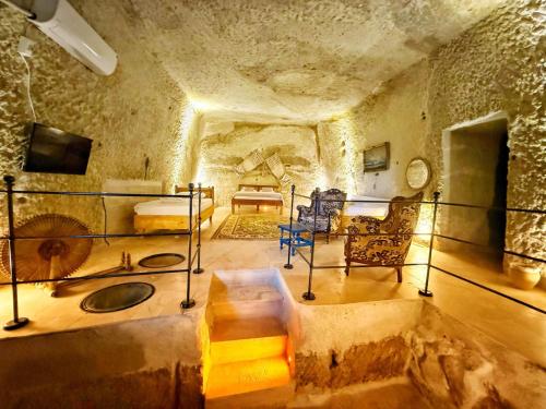 a room with a bed in a stone walled room at My Cave Suites in Nevsehir