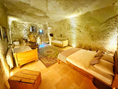 a bedroom with a large bed in a stone room at My Cave Suites in Nevsehir