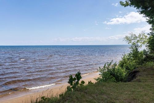 a beach with the ocean in the background at Adventure & Relaxation by Lake Superior in Paradise