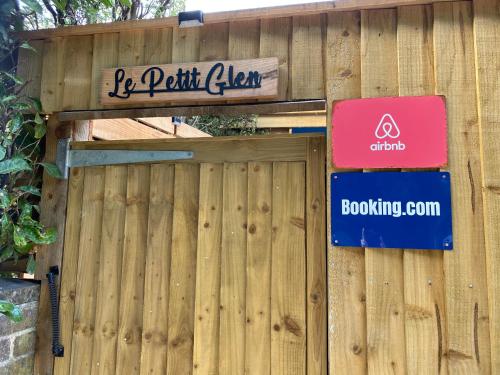 a wooden fence with a sign on it at Le Petit Glen Uplyme brand new accommodation in Uplyme
