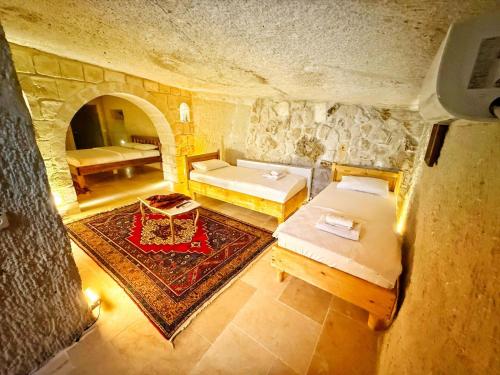 an overhead view of a bedroom with two beds and a table at My Cave Suites in Nevsehir