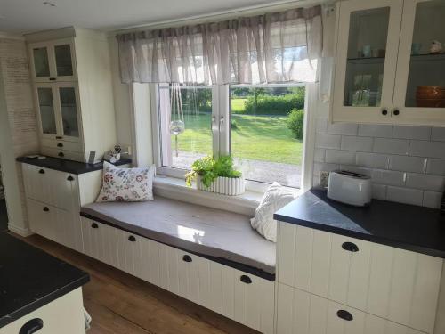 a kitchen with a bench in front of a window at Hus i Småland in Eksjö