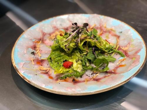 a plate of food with a salad on a table at CARIBBEAN VILLAS and SUITES - LOS CORALES beach - free wifi, free breakfast in Punta Cana