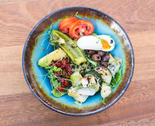 a plate of food with vegetables on a table at CARIBBEAN VILLAS and SUITES - LOS CORALES beach - free wifi, free breakfast in Punta Cana