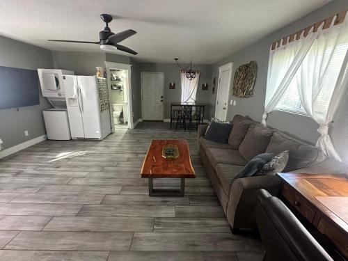a living room with a couch and a table at Tropical Mountain Valley Casita in Mesa