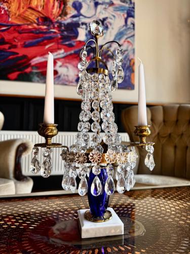 a chandelier with diamonds and crystals on a table at Vibrant Downtown Studio Oasis in Liepāja