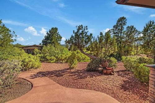 a walkway in a garden with trees and bushes at Sedona Retreat with Hot Tub and Views for Family in Sedona