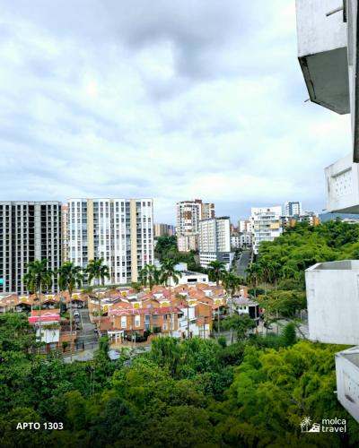a view of a city with tall buildings and trees at Apartamento en Armenia - Edificio Ambar - Con Piscina - By Molca Travel in Armenia