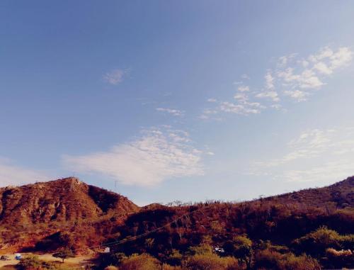 a kite flying in the sky over a mountain at Bungalows & Huerto en la montaña in San José del Cabo