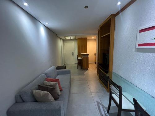 a living room with a couch and a television at Hotel Flat Moema UH 715 in Sao Paulo