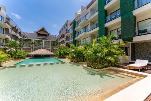 a swimming pool in the middle of a building at Bakal Studios in Tulum