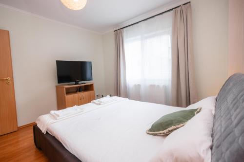 Ένα ή περισσότερα κρεβάτια σε δωμάτιο στο IZZY Apartament