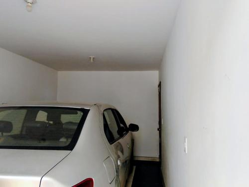 a white car is parked in a garage at Apto turístico a 5mn de la Basílica - Chiquinquirá in Chiquinquirá