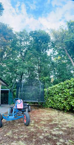 a small childs tricycle parked in a yard at Ons Schatje op 5-sterren vakantiepark De Schatberg in Sevenum