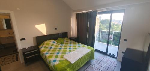 a bedroom with a bed and a large window at Dreamy luxury two-bedroom penthouse apartment with special forest, mountain and sea views in Alanya