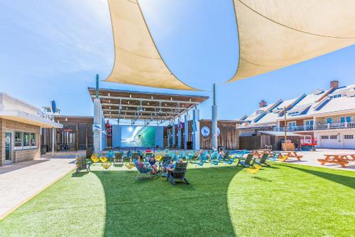 a large outdoor area with chairs and a pool at Prominence Moby Dick in Inlet Beach