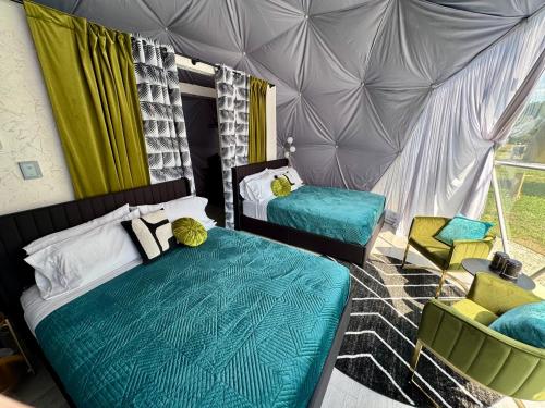 a bedroom with two beds and a tent at DayDreamer Domes in South Haven
