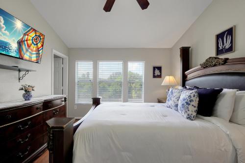 a bedroom with a large white bed and a window at Windsor Hills Resort - Water Park - Private Heated Plunge Pool - Near Disney in Orlando