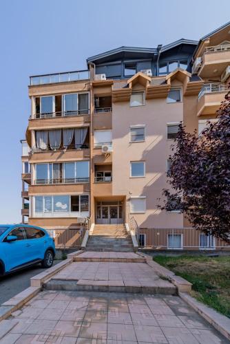a building with a car parked in front of it at Mademoiselle Spa Apartment in Belgrade