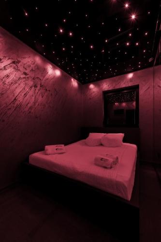 a room with a bed in a pink room at Mademoiselle Spa Apartment in Belgrade