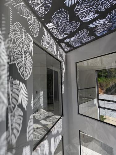 a room with a mirror and a wall with a mural at Finca Las palmas Guatape in Guatapé