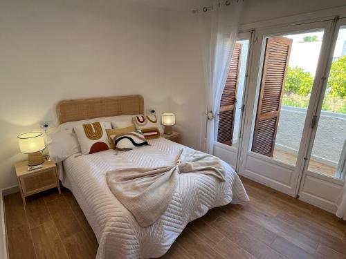 a bedroom with a large bed and a window at Ideal modern bungalow MA1 in Torrevieja