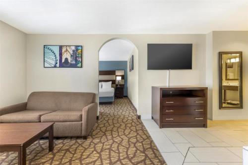 a living room with a couch and a flat screen tv at Best Western Joliet Inn & Suites in Joliet