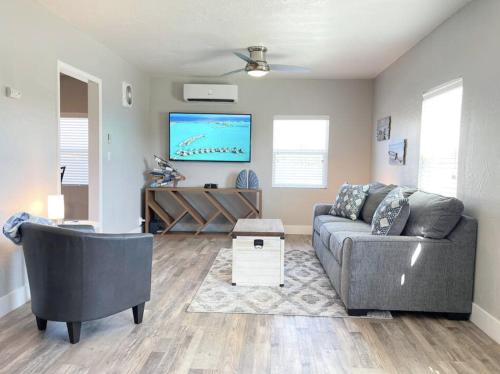 a living room with a couch and a flat screen tv at Ocean Breeze Harrison Ranch 2 in Visalia