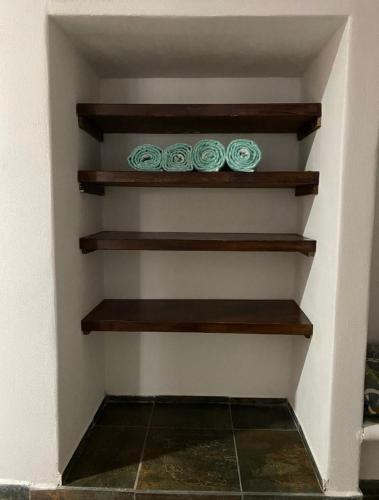 a room with wooden shelves on a wall at Costa Ayala casa para 18 personas a cuadra y media de la playa in Los Ayala