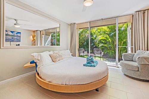 a bedroom with a bed and a living room with a couch at Napili Ridge - Vacation West Maui in Lahaina