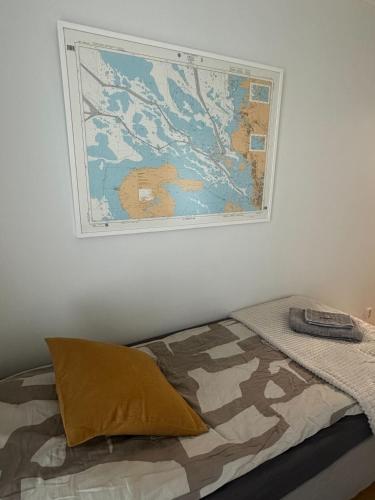 a bedroom with a bed with a map on the wall at Virpiniemen Maston Villa, Oulu in Oulu