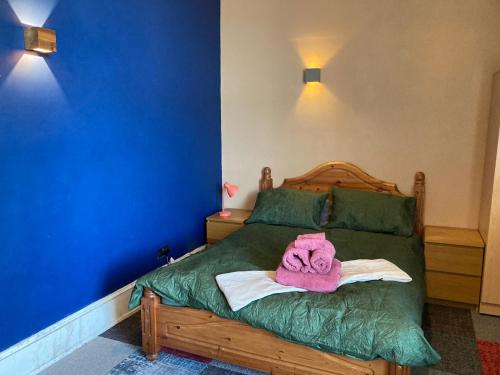 a bedroom with a bed with a towel on it at The Tartan Sheep in Kilmarnock