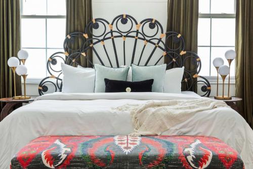 a bedroom with a large bed with a black headboard at Mystique in Atlanta