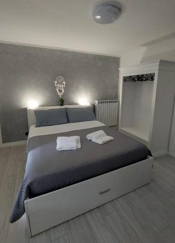 a bedroom with a large bed with two towels on it at La Casa Di Memole in Giaveno