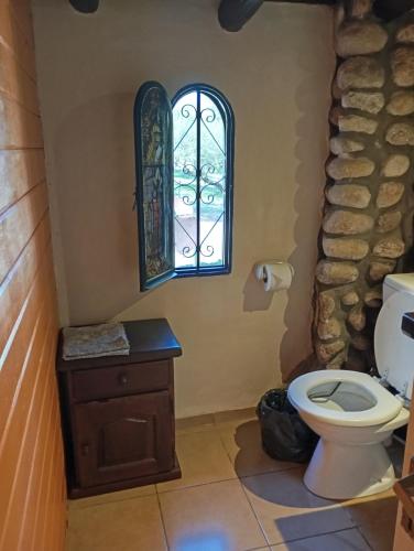 a bathroom with a toilet and a window at Posada de Nono in Nono